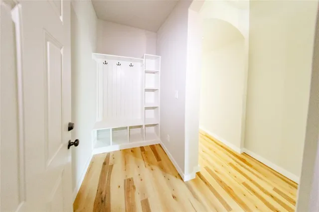 a view of a living room hardwood floor and a kitchen