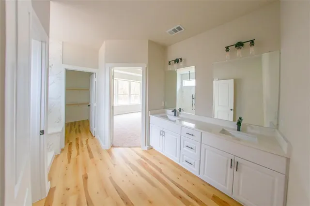 an empty room with a ceiling fan and windows