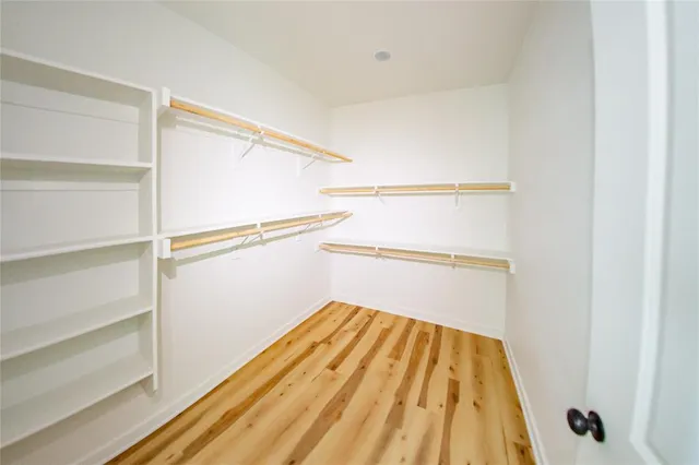 a view of a bathroom with a shower and a room
