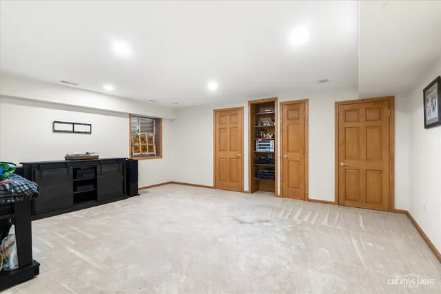 an empty room with closet and natural light