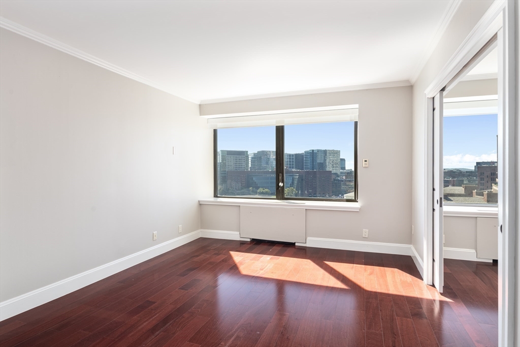 85 East India Row, Unit 15E Boston, MA 02110 - Photo 12 of 20 a view of empty room with wooden floor and fan
