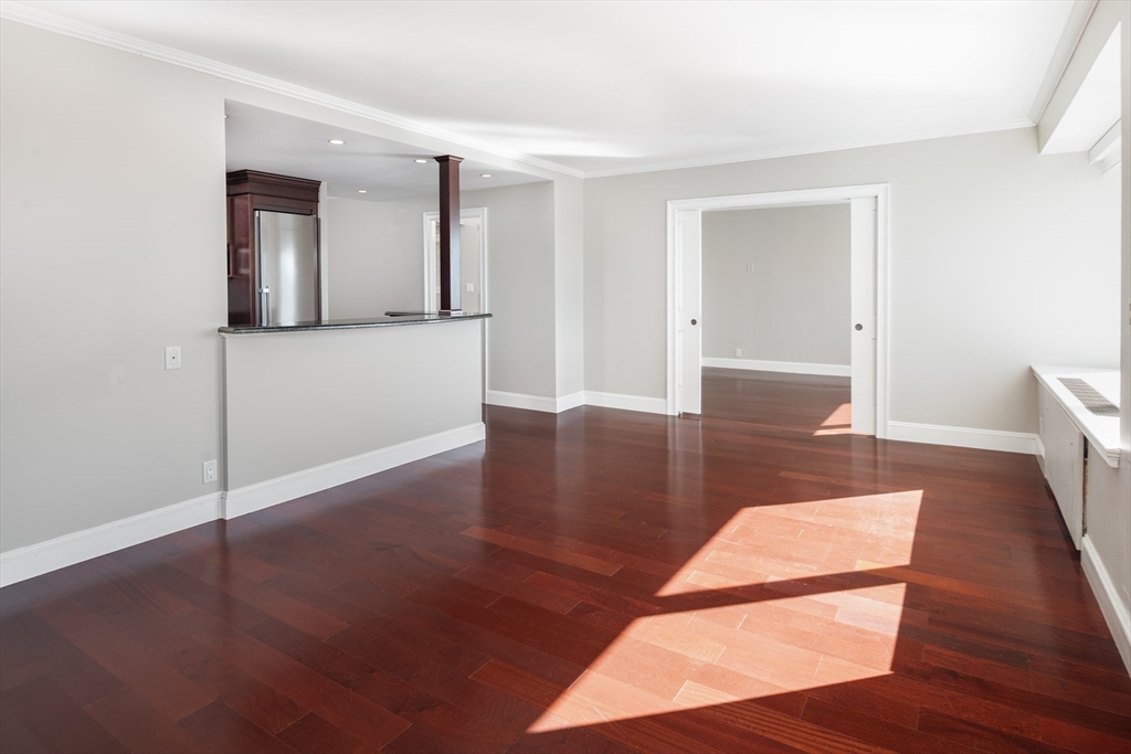 85 East India Row, Unit 15E Boston, MA 02110 - Photo 3 of 20 a view of a room with wooden floor and cabinet