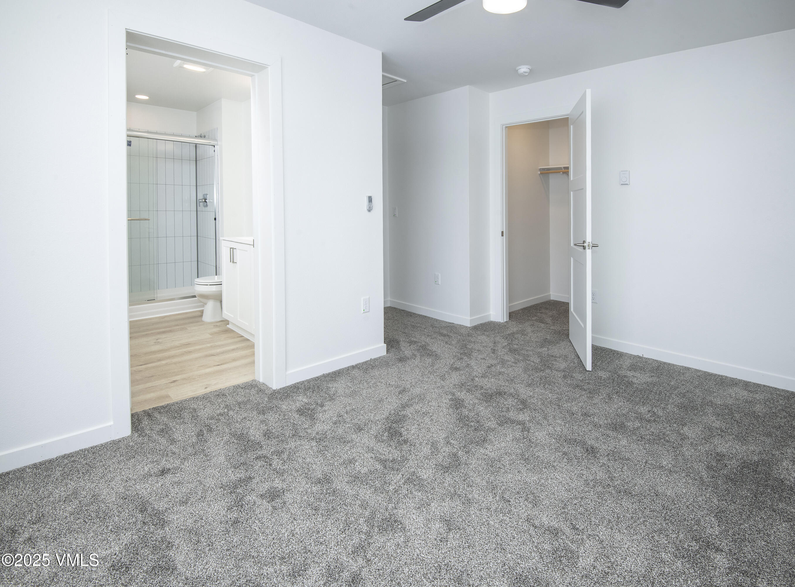 70 Comanche Way Gypsum, CO 81637 - Photo 16 of 46 an empty room with windows and entrance to other room
