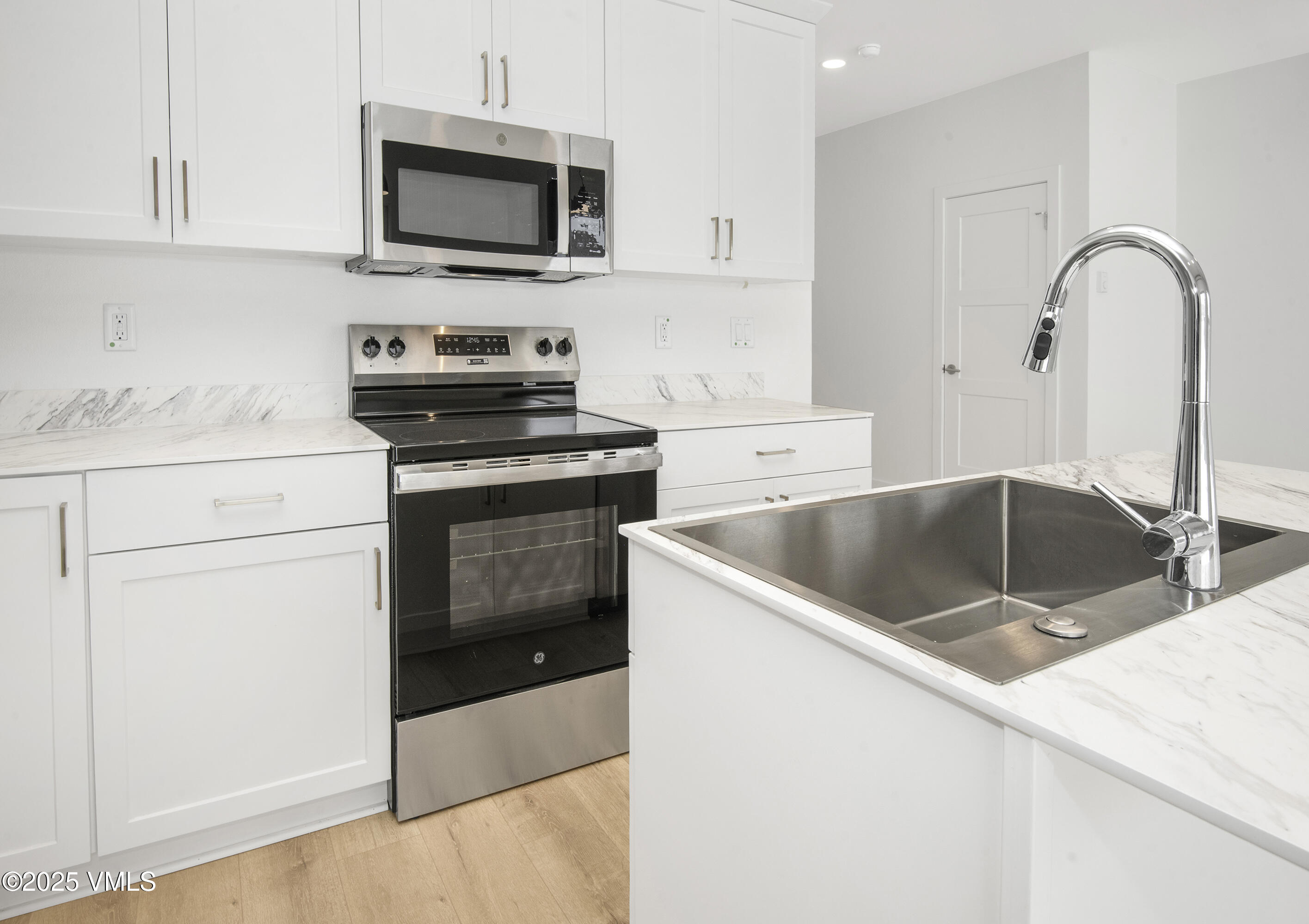 70 Comanche Way Gypsum, CO 81637 - Photo 5 of 46 a kitchen with stainless steel appliances granite countertop a sink a microwave a stove and refrigerator