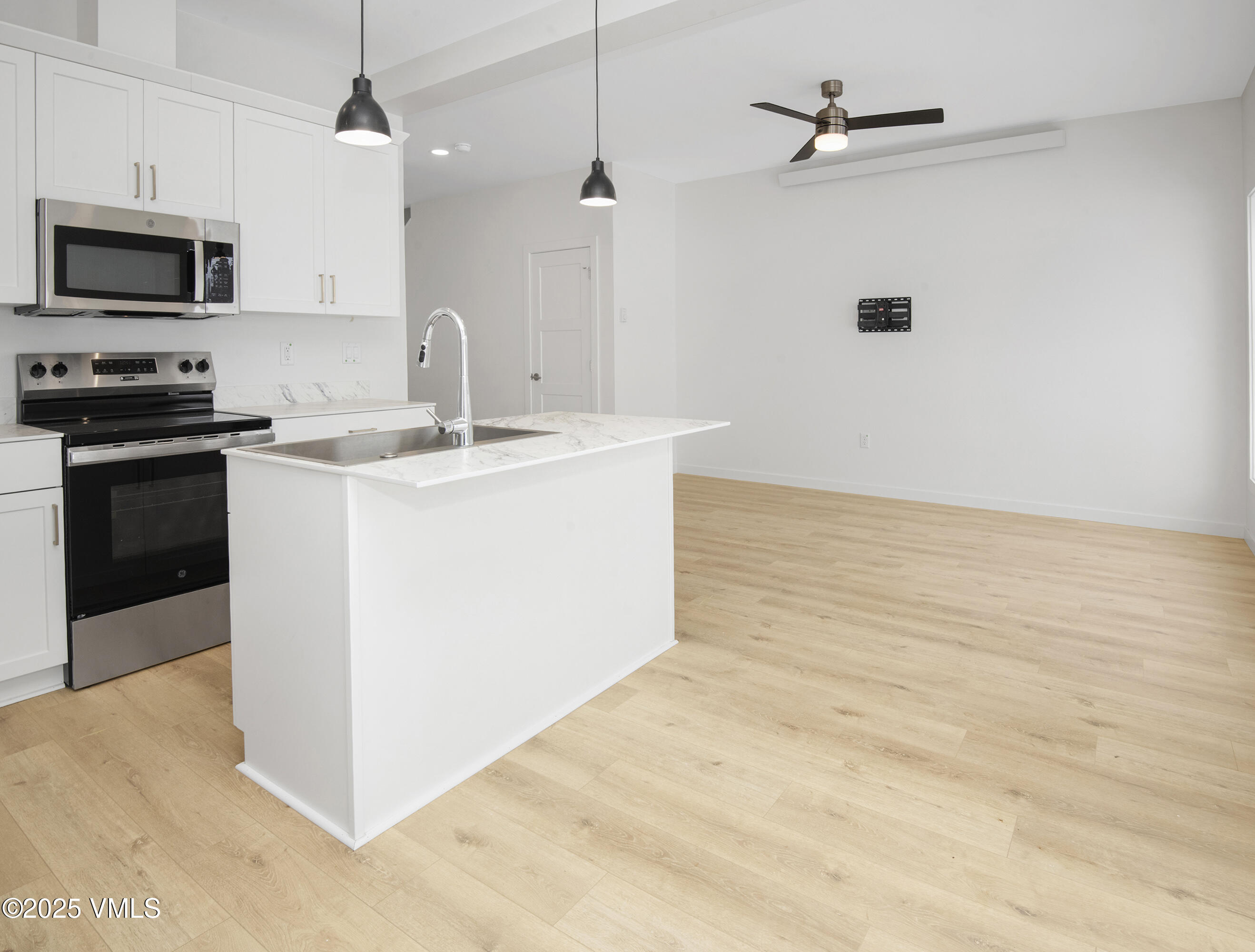 70 Comanche Way Gypsum, CO 81637 - Photo 6 of 46 a kitchen with kitchen island granite countertop a sink and a stove top oven