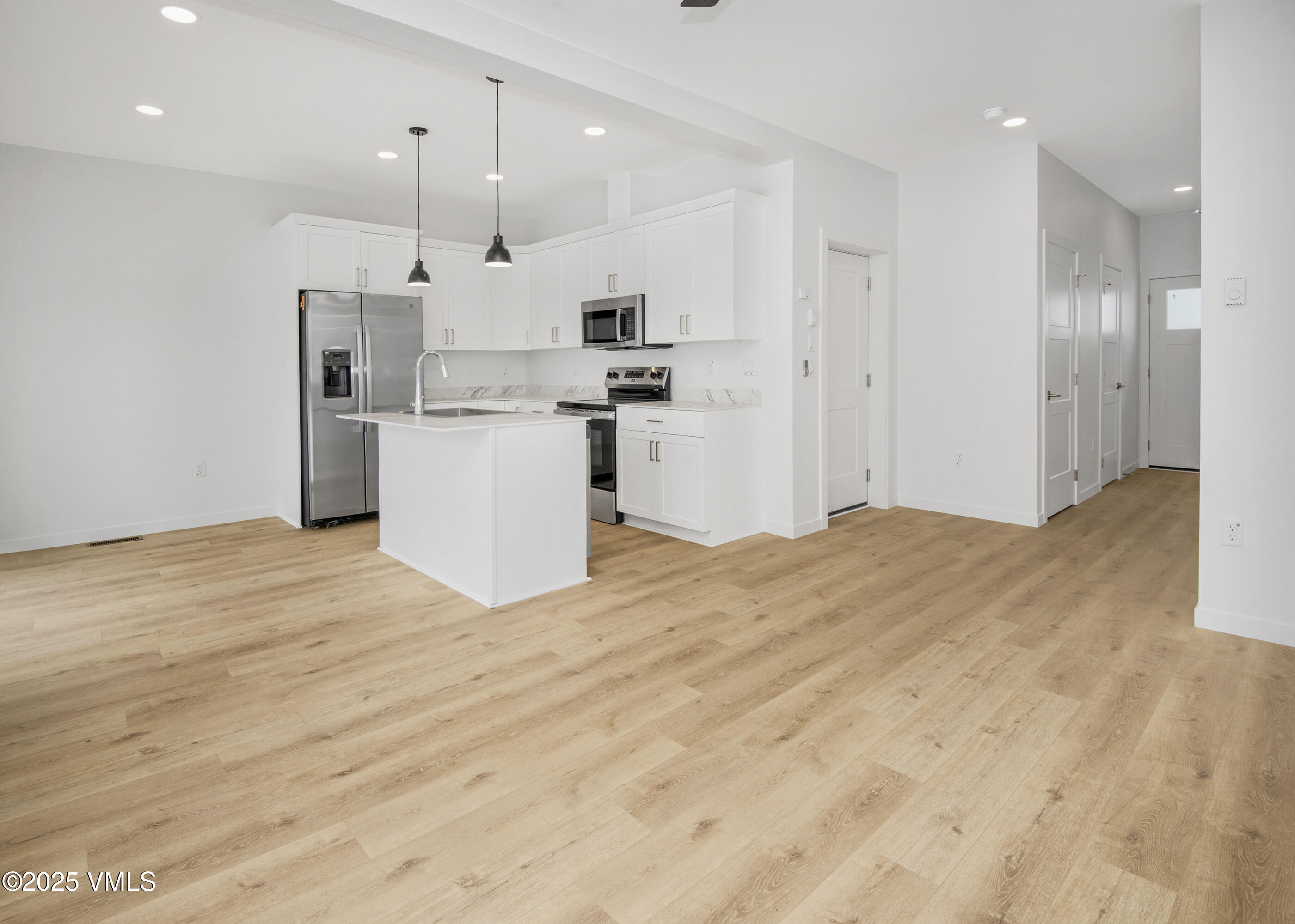 70 Comanche Way Gypsum, CO 81637 - Photo 7 of 46 a large kitchen with kitchen island a sink stainless steel appliances and cabinets