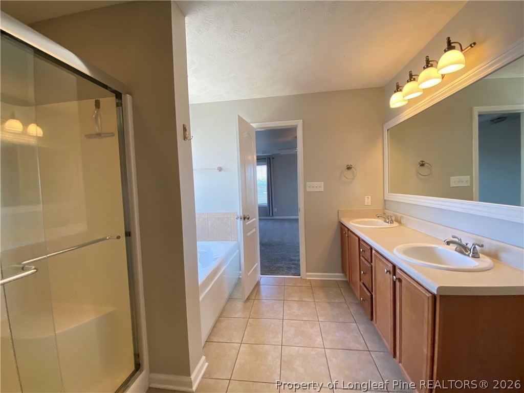 58 Polk Street Spring Lake, NC 28390 - Photo 15 of 26 a bathroom with a sink a toilet and shower