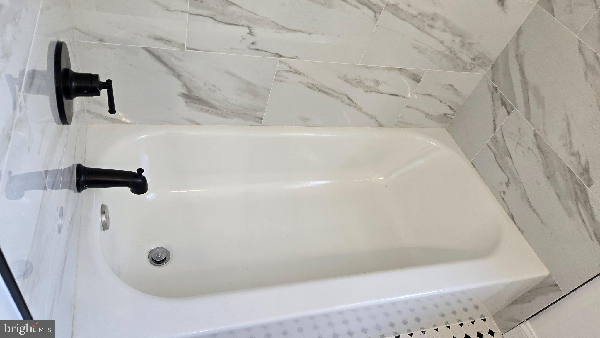 3820 Elkader Road Baltimore, MD 21218 - Photo 33 of 41 Sleek tub in modern marble setting.