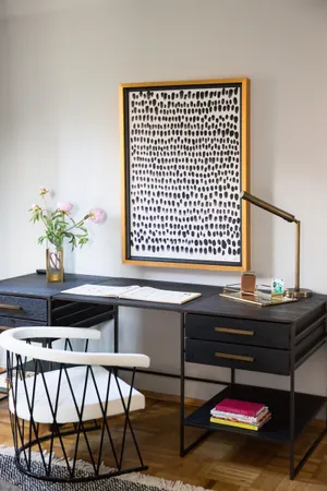 a living room with a couch and a potted plant