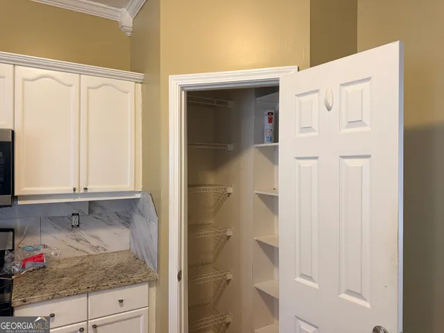a bathroom with a granite countertop sink and shower