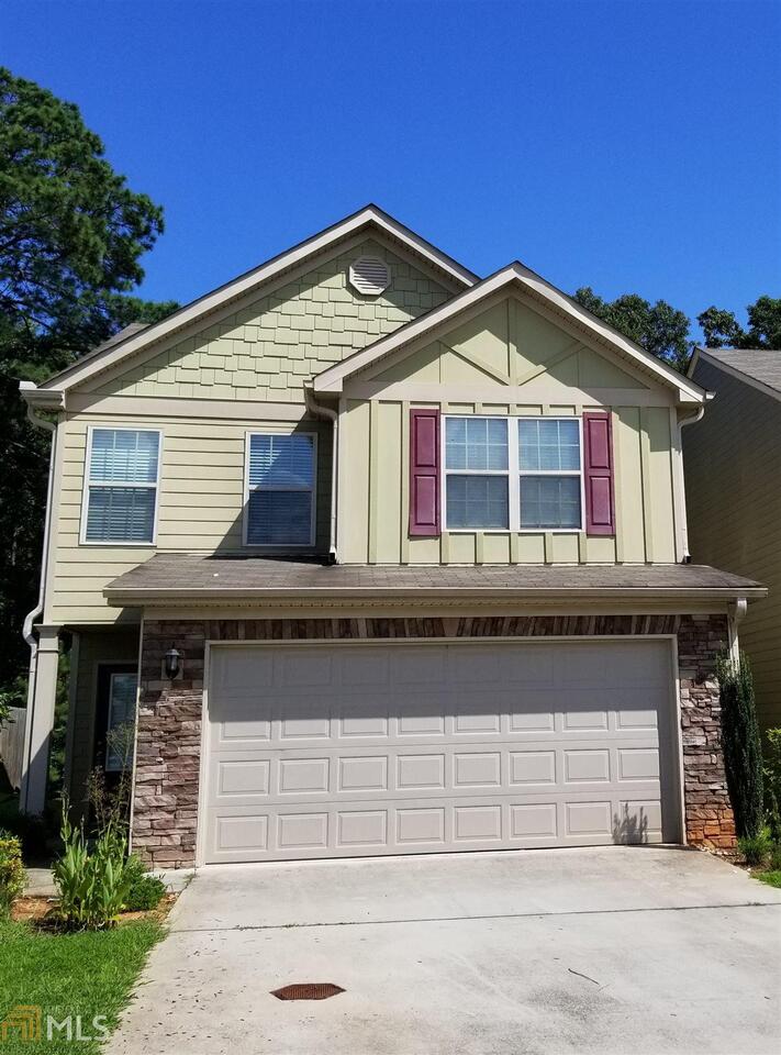 2441 Capella Circle Southwest Atlanta, GA 30331 - Photo 1 of 12 a front view of a house with garage