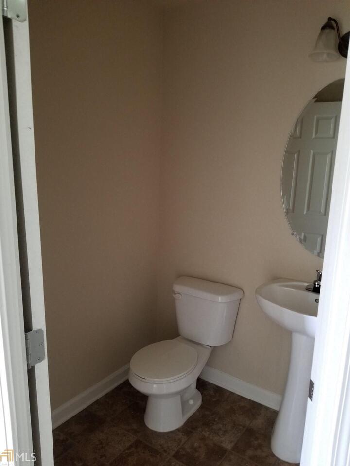 2441 Capella Circle Southwest Atlanta, GA 30331 - Photo 2 of 12 a white toilet sitting next to a small sink
