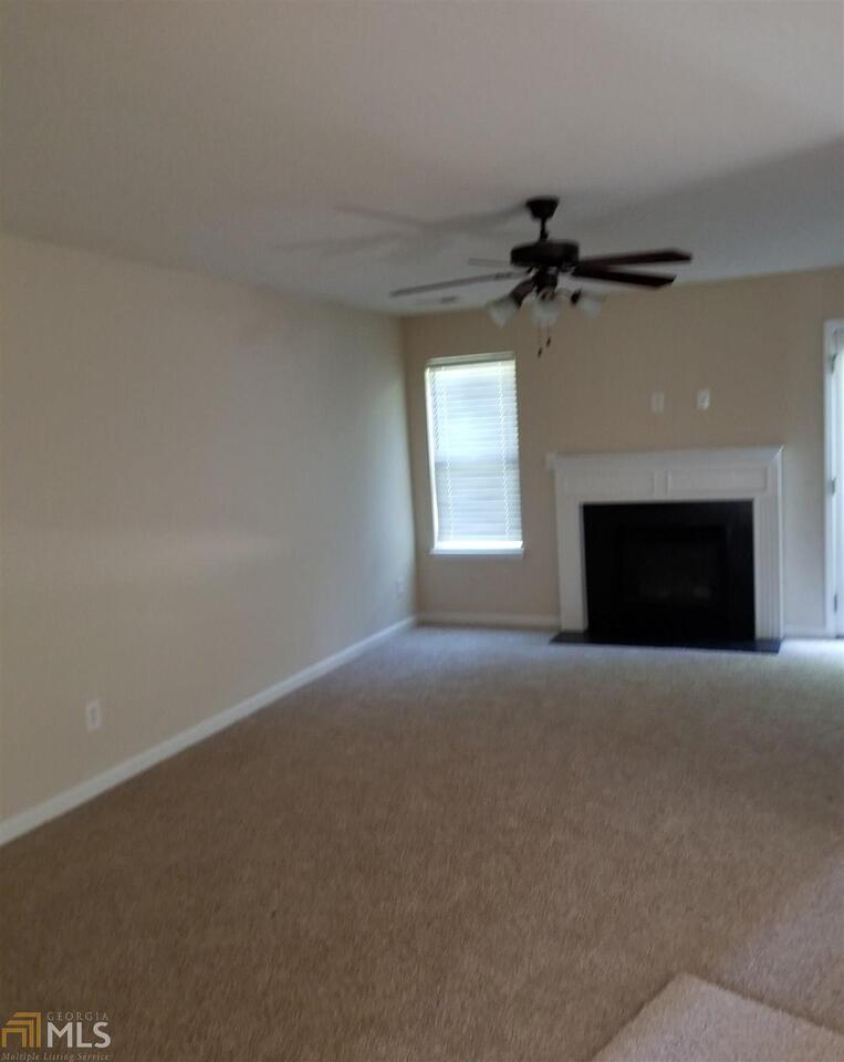 2441 Capella Circle Southwest Atlanta, GA 30331 - Photo 4 of 12 en empty room with windows and fireplace