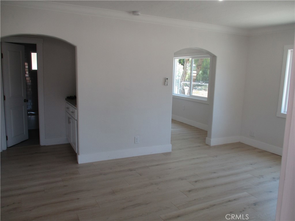 28584 Goetz Road Menifee, CA 92587 - Photo 4 of 10 an empty room with wooden floor and a window