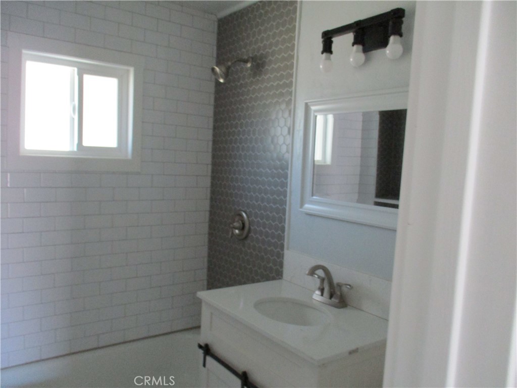 28584 Goetz Road Menifee, CA 92587 - Photo 9 of 10 a bathroom with a sink and mirror