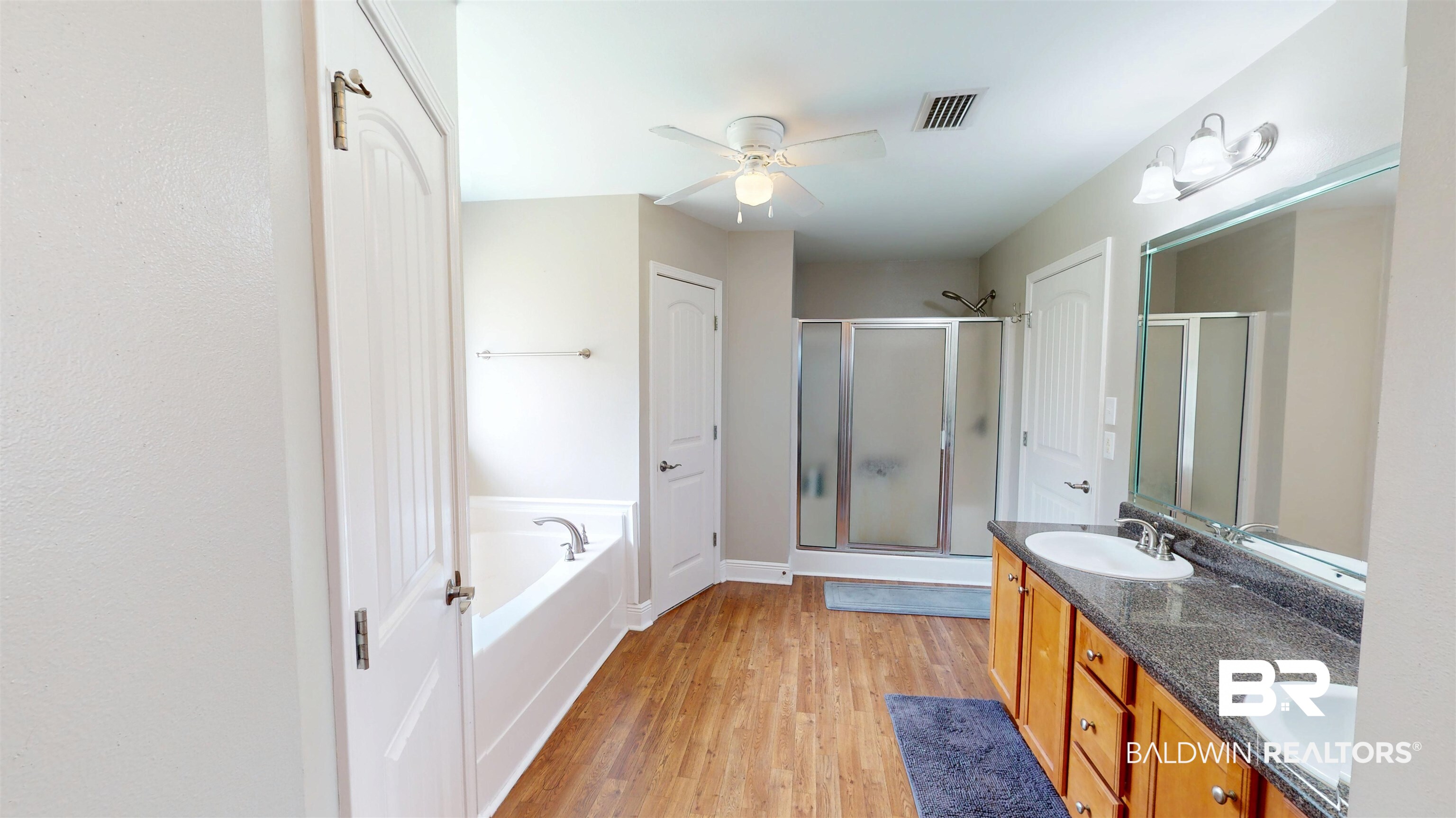 10753 Rigby Drive Mobile, AL 36695 - Photo 15 of 33 Primary en suite has double vanities, walk-in shower, garden soaker tub, and accesses 2 walk-in closets.