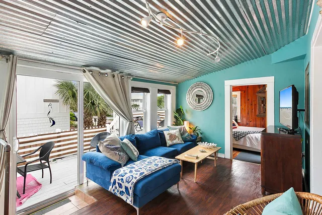 a view of a kitchen with a stove a sink and a window