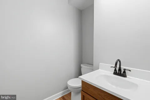 a bathroom with a sink a toilet and mirror