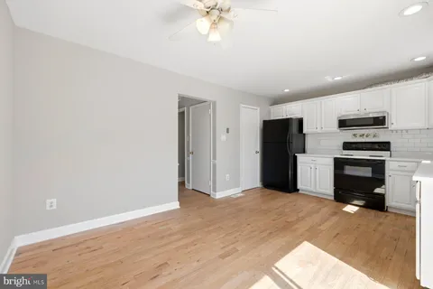 a view of kitchen with refrigerator and microwave