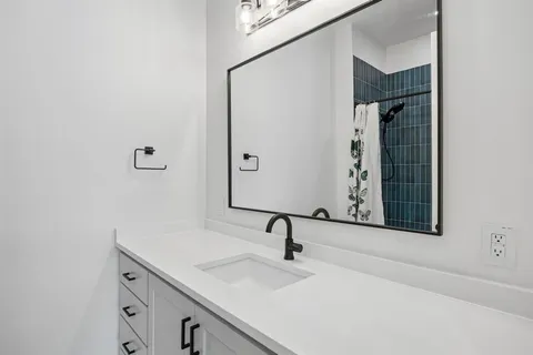 a bathroom with a bathtub and shower
