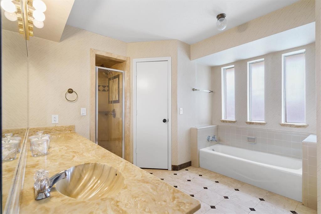 2214 Valley Mill Carrollton, TX 75006 - Photo 23 of 36 a bathroom with a bathtub and a shower