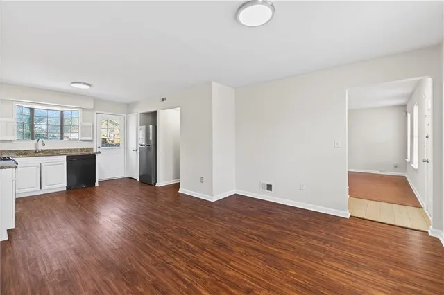 a view of a kitchen with wooden floor and a sink