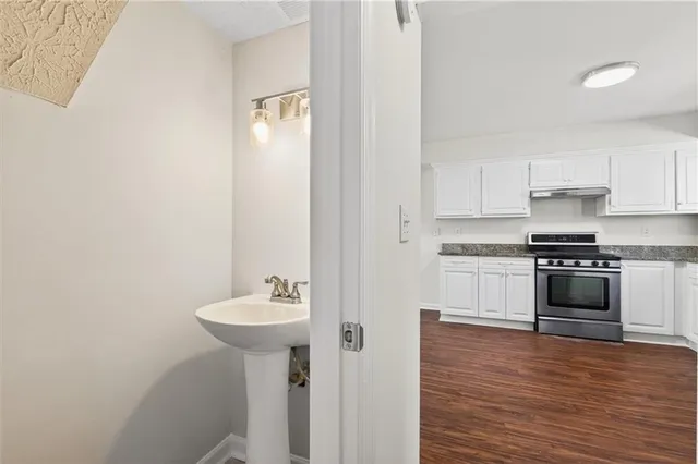 a kitchen with a sink and a stove top oven