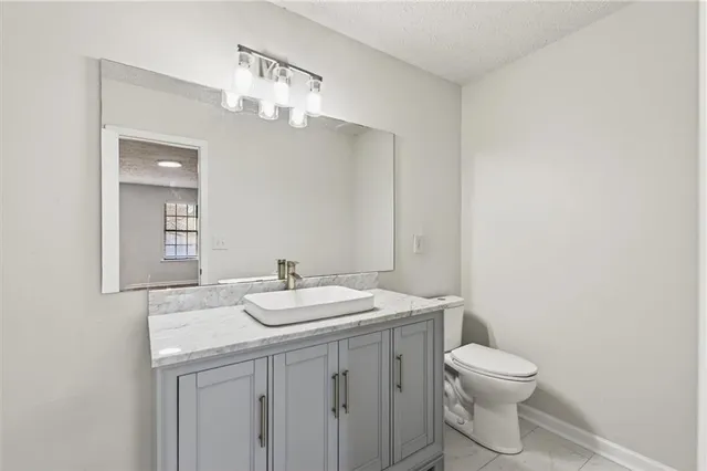 a bathroom with a toilet a sink and mirror