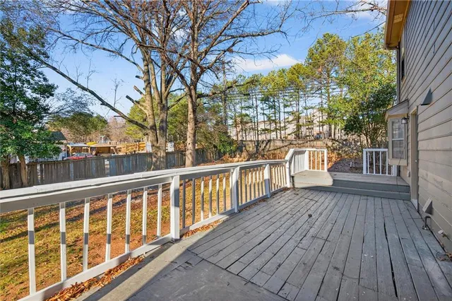 a view of a balcony with wooden floor and fence
