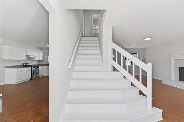 a view of entryway and hall with wooden floor