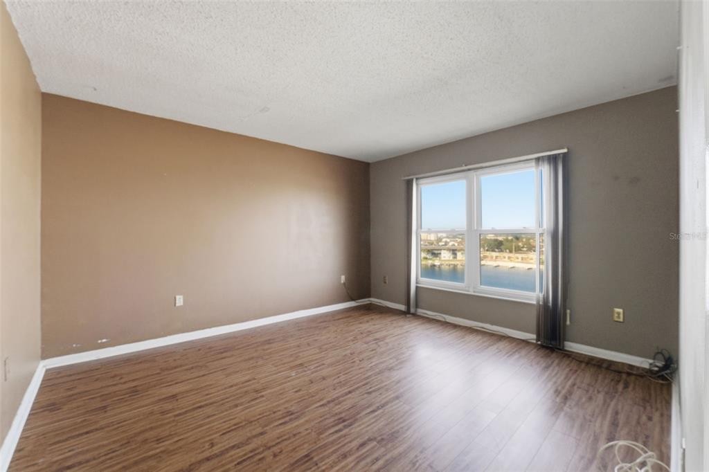 4939 Floramar Terrace, Unit 712 New Port Richey, FL 34652 - Photo 15 of 41 a view of an empty room with wooden floor and a window