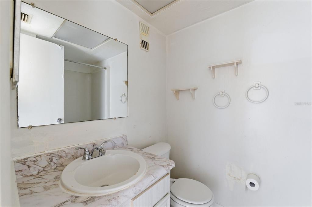 4939 Floramar Terrace, Unit 712 New Port Richey, FL 34652 - Photo 19 of 41 a bathroom with a sink toilet and shower
