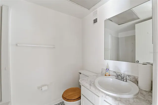 a bathroom with a sink a toilet and mirror