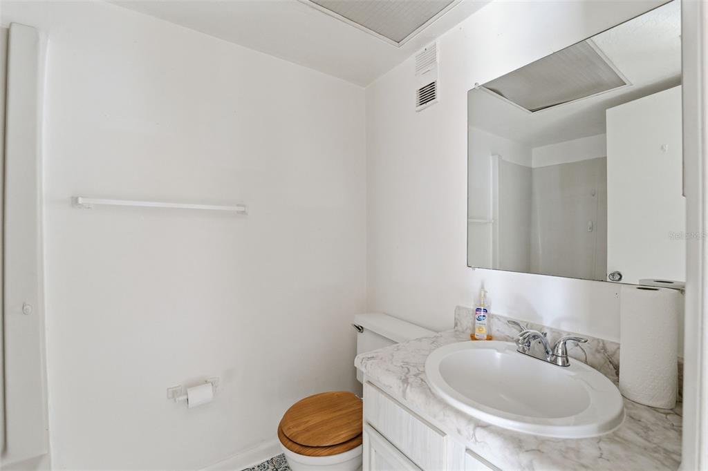 4939 Floramar Terrace, Unit 712 New Port Richey, FL 34652 - Photo 22 of 41 a bathroom with a sink a toilet and mirror