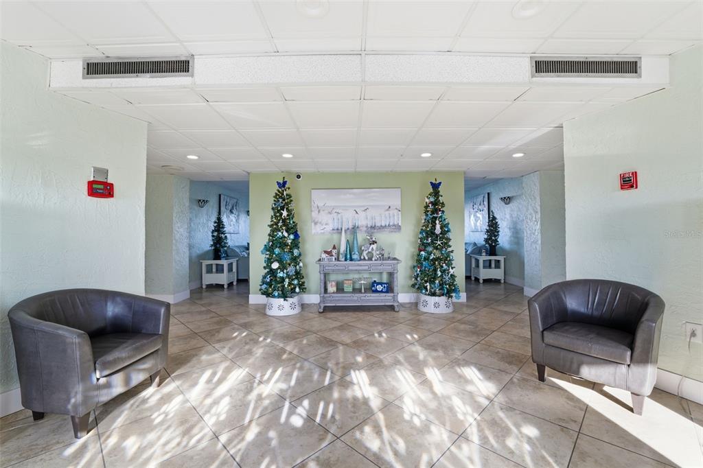 4939 Floramar Terrace, Unit 712 New Port Richey, FL 34652 - Photo 24 of 41 a living room with furniture and a potted plant