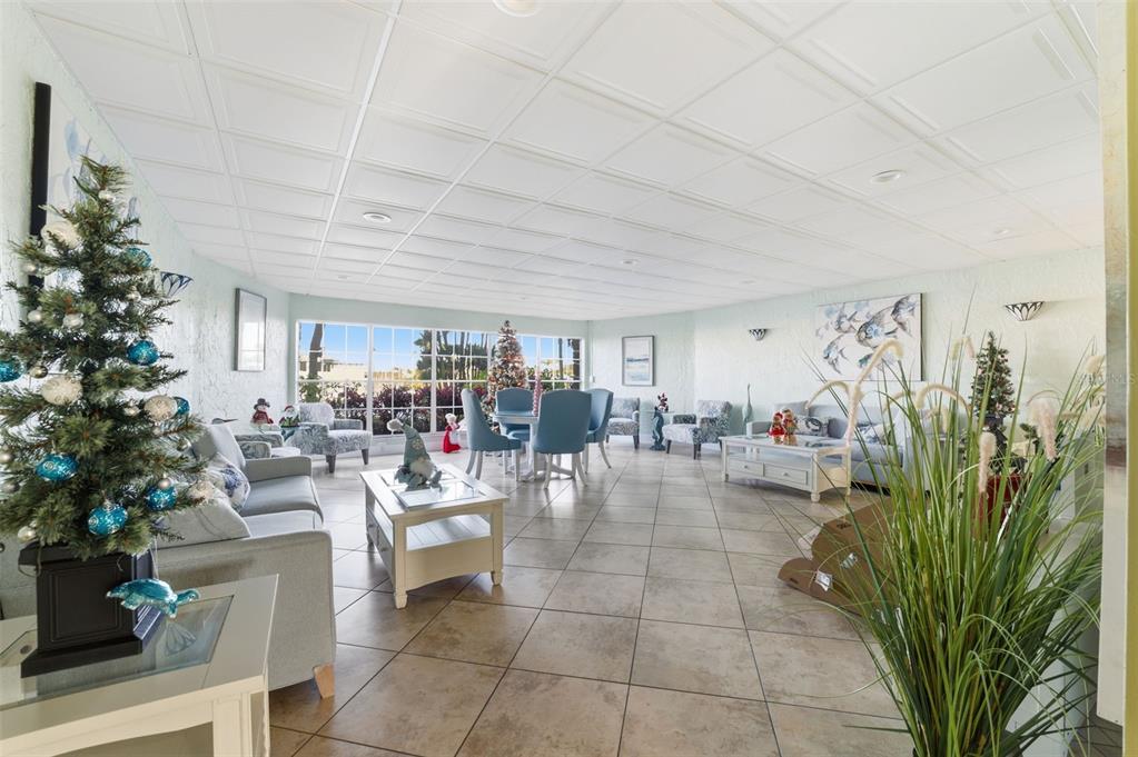 4939 Floramar Terrace, Unit 712 New Port Richey, FL 34652 - Photo 25 of 41 a living room with furniture a potted plant and a large window