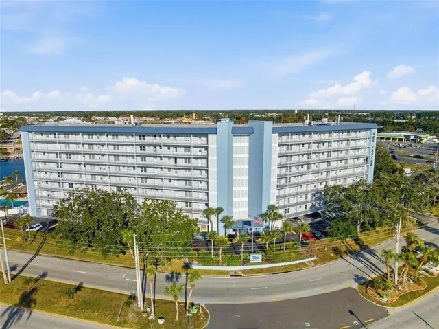 a view of building with yard and swimming pool