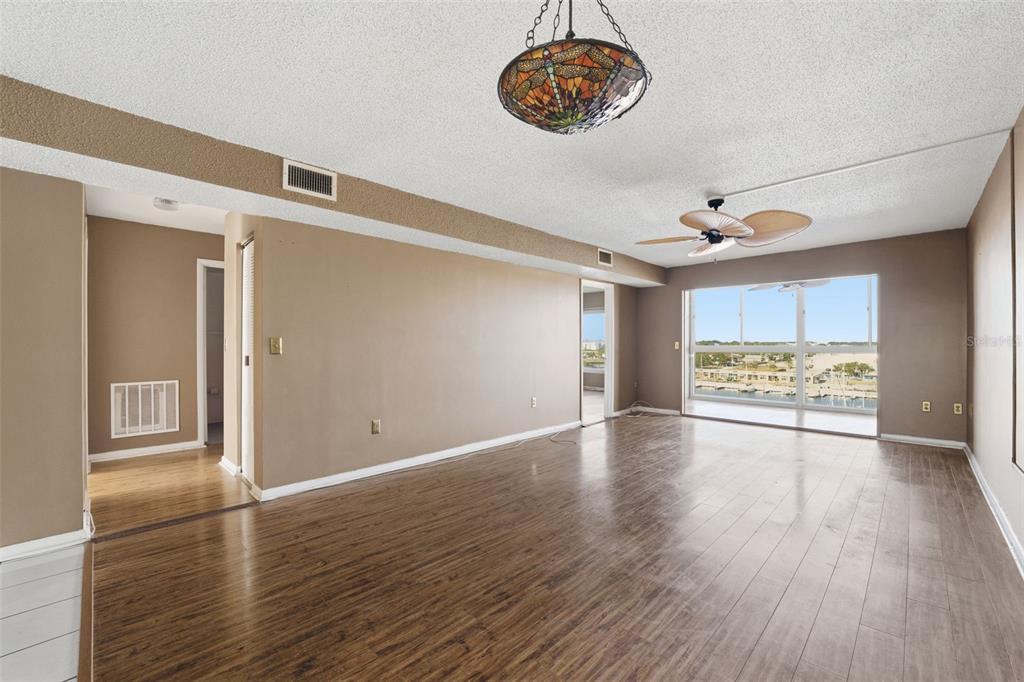 4939 Floramar Terrace, Unit 712 New Port Richey, FL 34652 - Photo 7 of 41 a view of an empty room with a window and wooden floor
