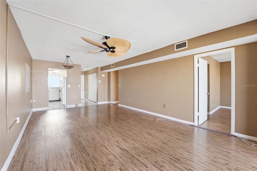 4939 Floramar Terrace, Unit 712 New Port Richey, FL 34652 - Photo 9 of 41 a view of an empty room with wooden floor and a window