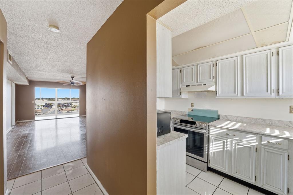 4939 Floramar Terrace, Unit 712 New Port Richey, FL 34652 - Photo 10 of 41 a kitchen with granite countertop a sink and cabinets