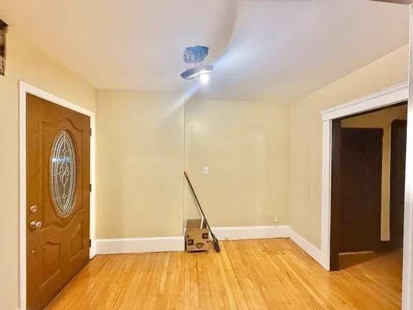 a view of empty room with wooden floor