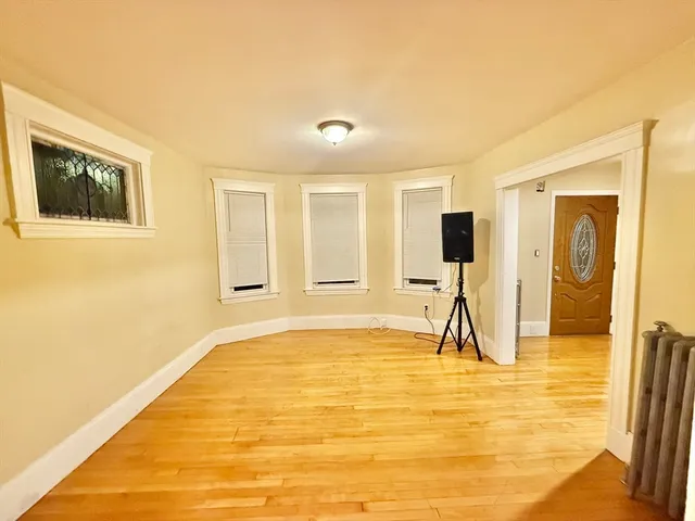 a living room with a large window and a flat screen tv