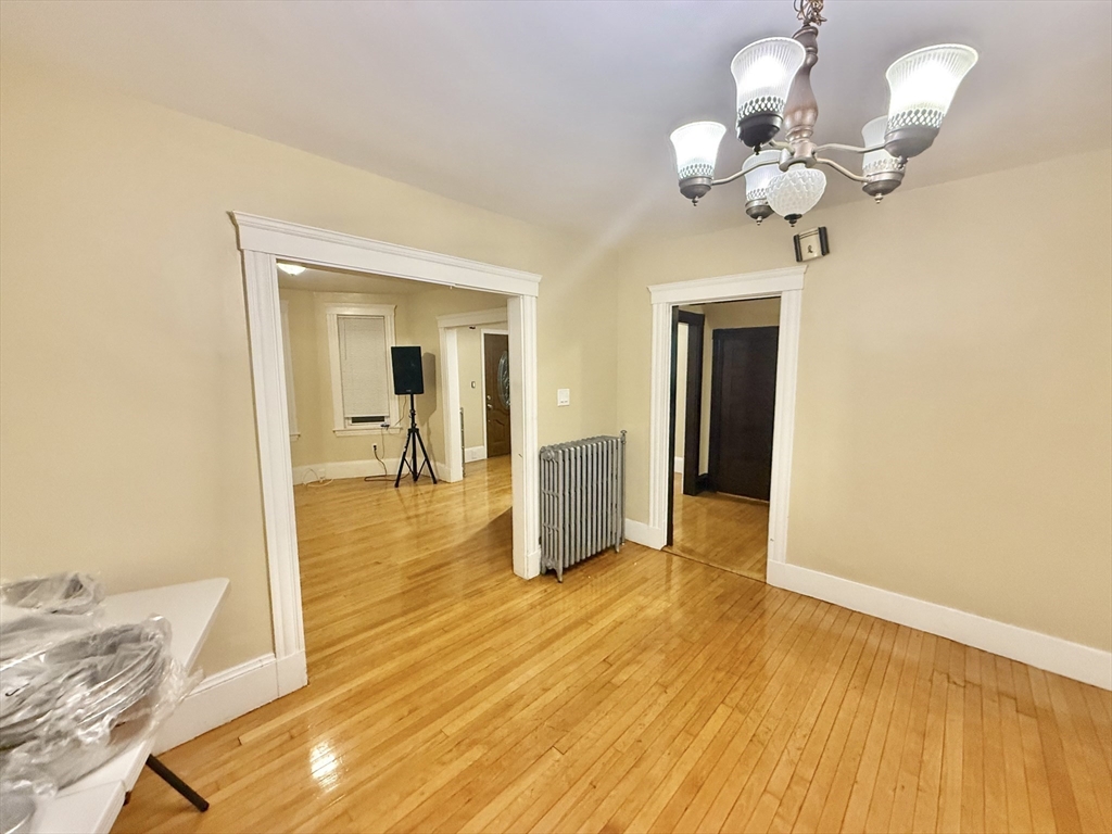23 Pearl Street, Unit 1 Everett, MA 02149 - Photo 5 of 13 a view of a room with wooden floor and chandelier