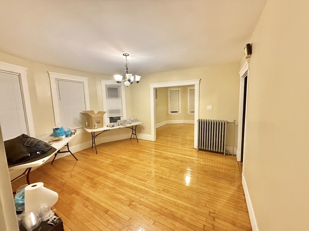 23 Pearl Street, Unit 1 Everett, MA 02149 - Photo 6 of 13 a living room with furniture and a chandelier