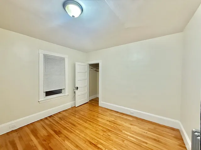 a view of a room with wooden floor and white walls