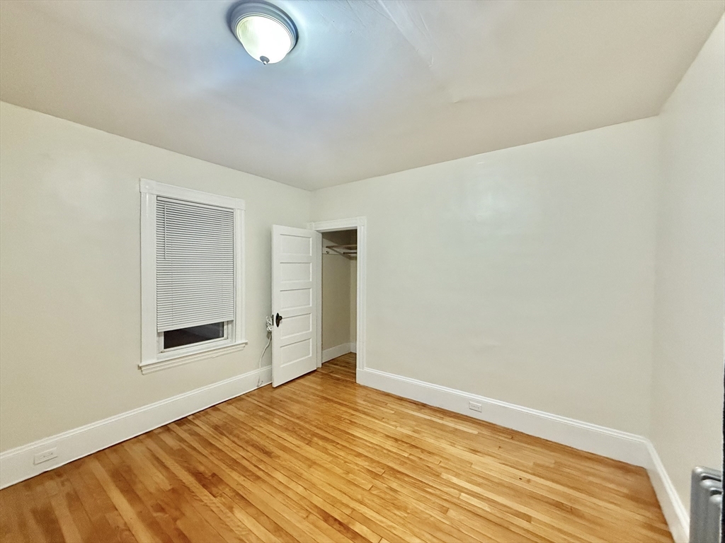 23 Pearl Street, Unit 1 Everett, MA 02149 - Photo 10 of 13 a view of a room with wooden floor and white walls