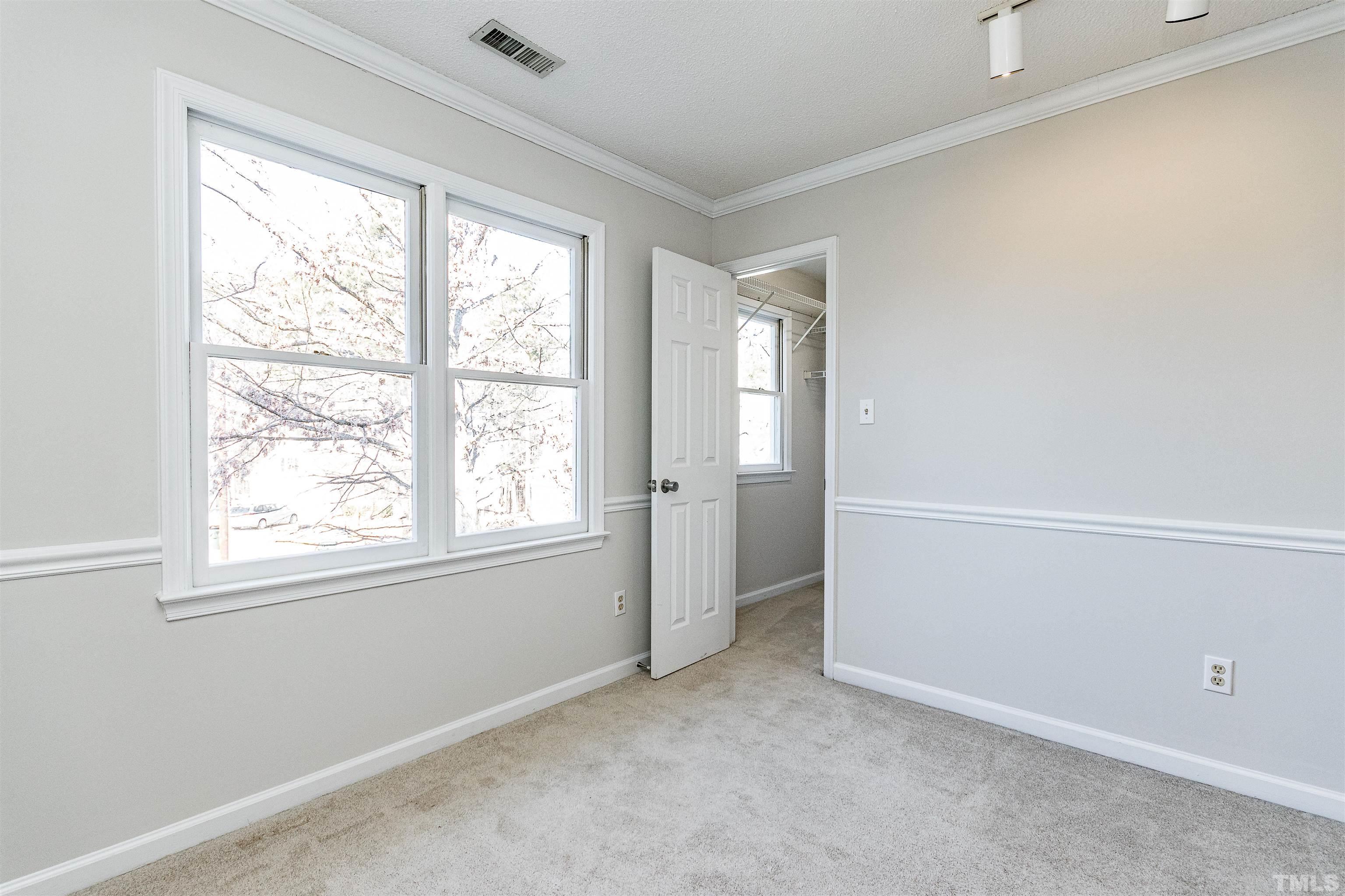 11801 Fairlie Place Raleigh, NC 27613 - Photo 19 of 32 an empty room with windows