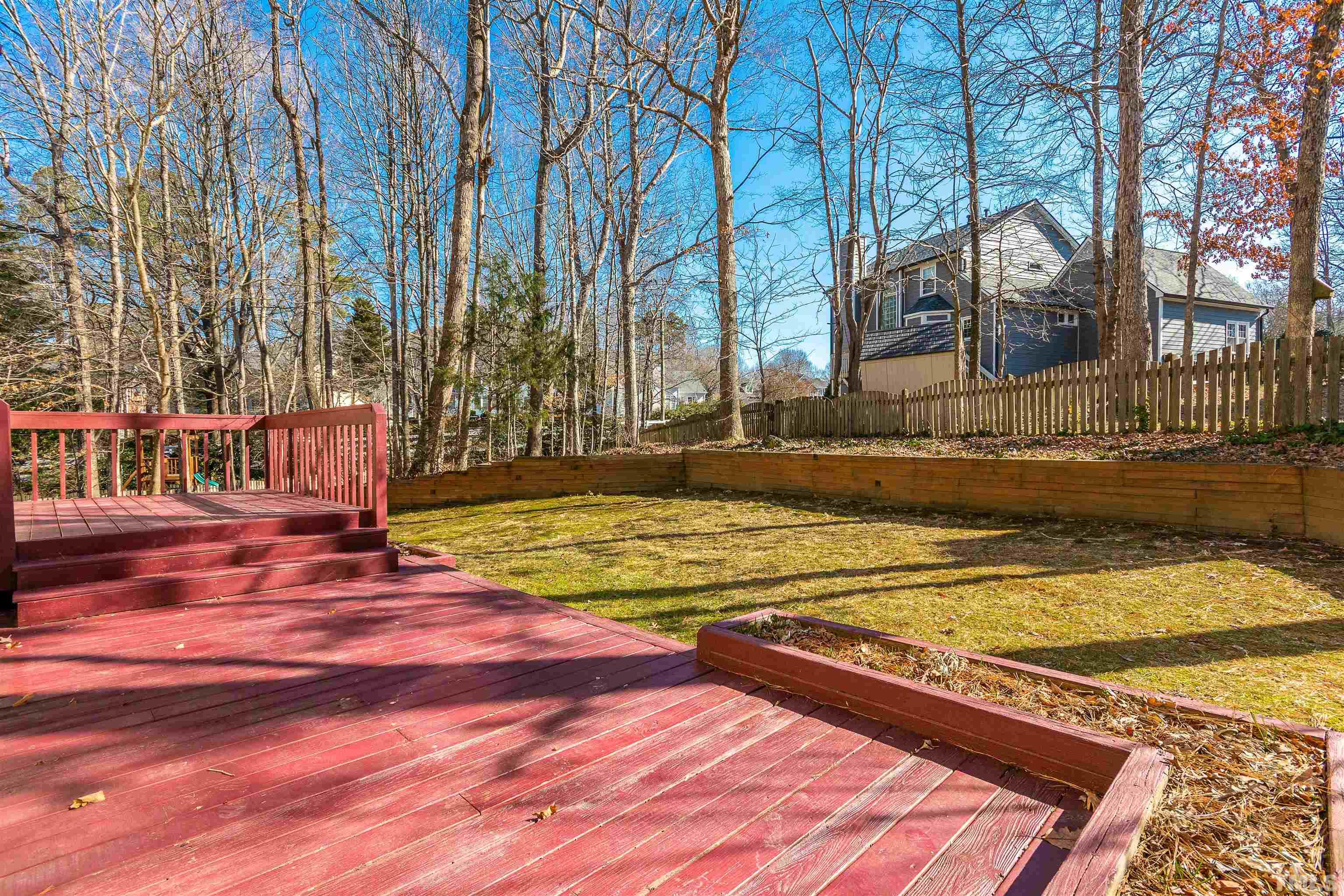 11801 Fairlie Place Raleigh, NC 27613 - Photo 23 of 32 a view of swimming pool with large trees and wooden fence