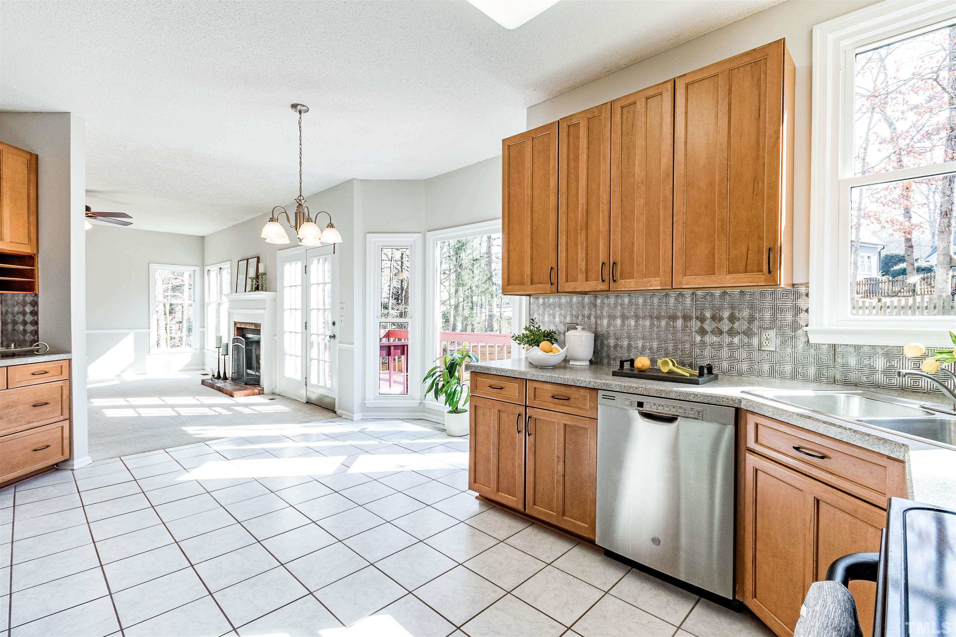 11801 Fairlie Place Raleigh, NC 27613 - Photo 6 of 32 a kitchen with stainless steel appliances granite countertop a stove a sink and a refrigerator