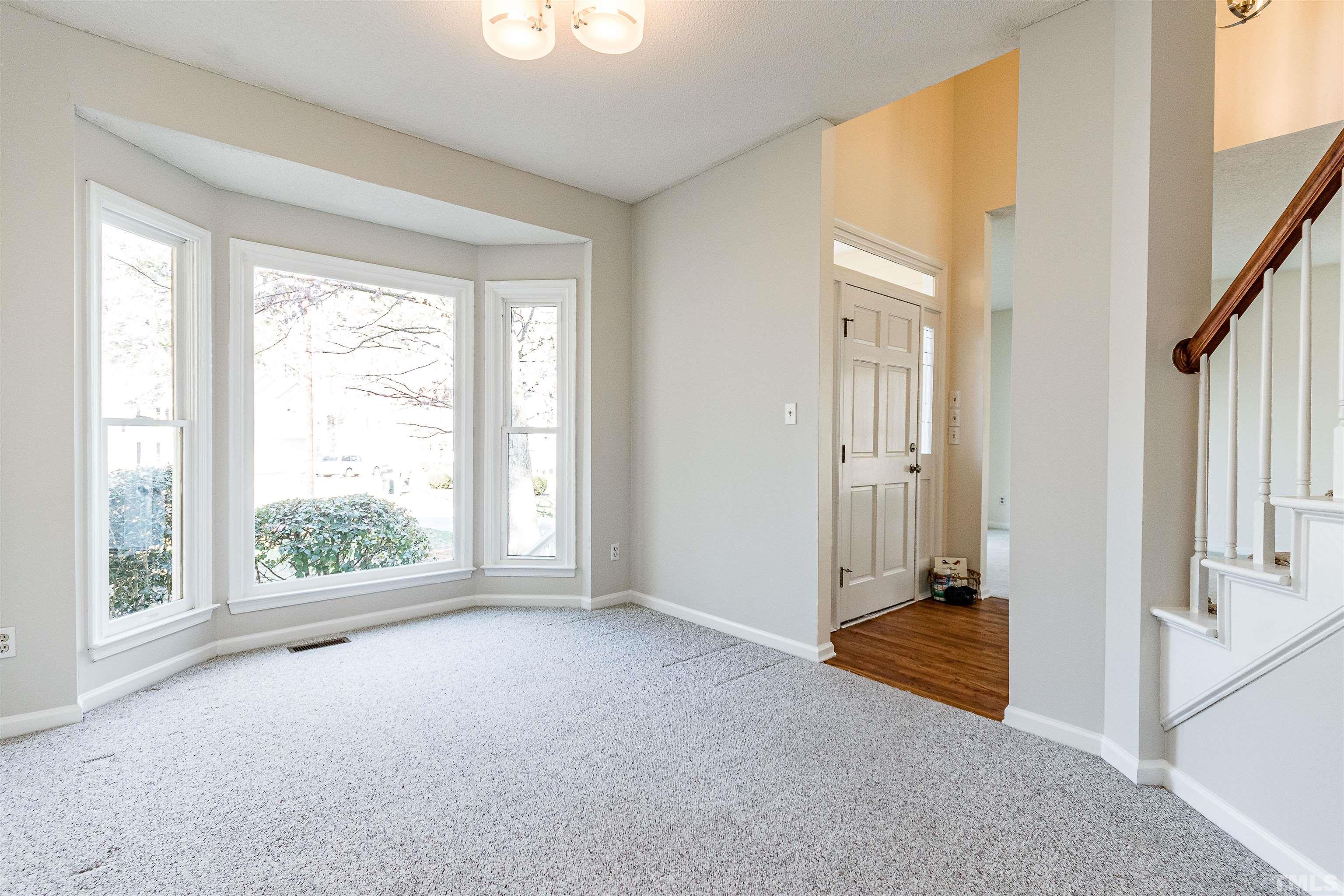11801 Fairlie Place Raleigh, NC 27613 - Photo 10 of 32 an empty room with windows